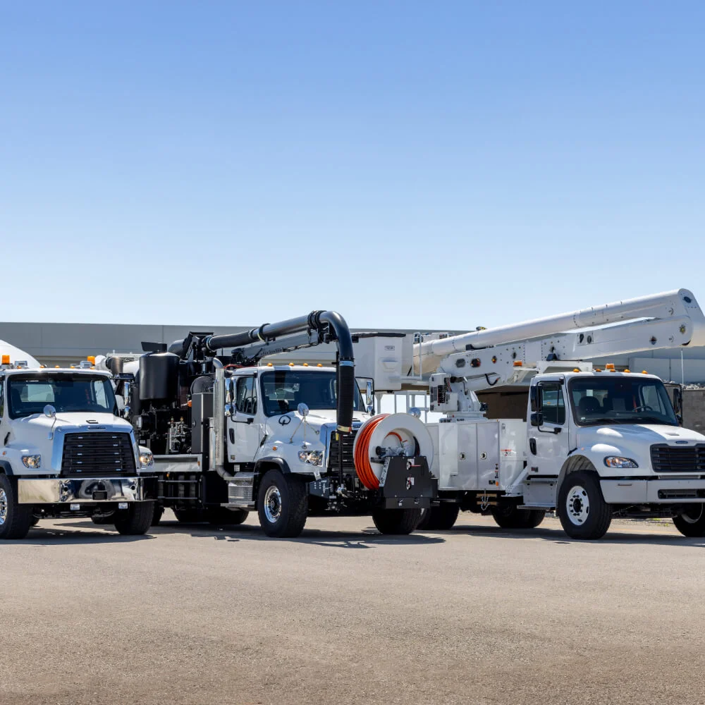 The image showcases the versatility of the Freightliner brand, highlighting different applications of the 108SD and the M2. On the left, the Freightliner 108SD is equipped with a heavy-duty vacuum system, making it ideal for industrial cleaning, waste management, and other specialized tasks. The middle 108SD has been fitted with an extended boom, perfect for utilities, telecommunications, or tree trimming operations. On the right, the Freightliner M2 is designed for a diverse range of medium-duty tasks and can be configured for various applications, from cargo transport to specialized services. Each vehicle's design emphasizes robustness, durability, and the ability to be tailored to specific industry needs. The consistent branding across different models and applications underscores Freightliner's commitment to providing reliable solutions for a myriad of industrial demands.